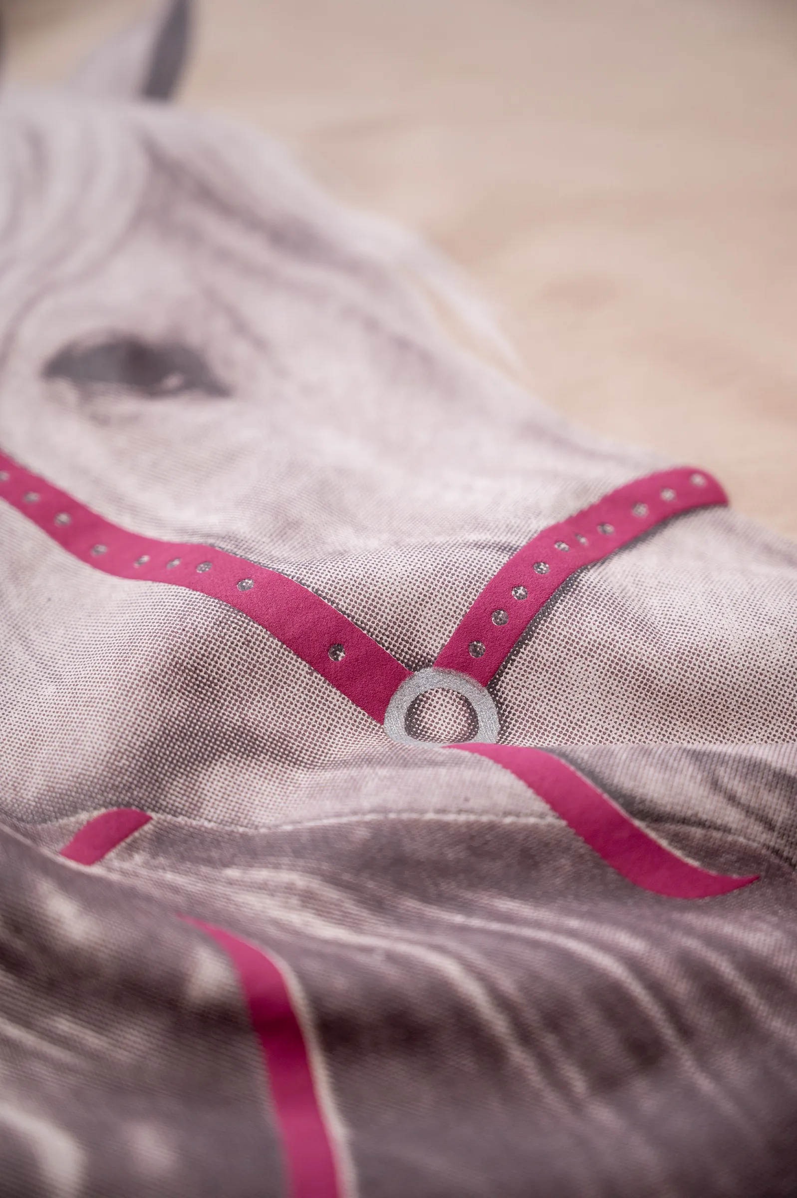 Macro detail of the puff print halter strap over the screen-printed horse