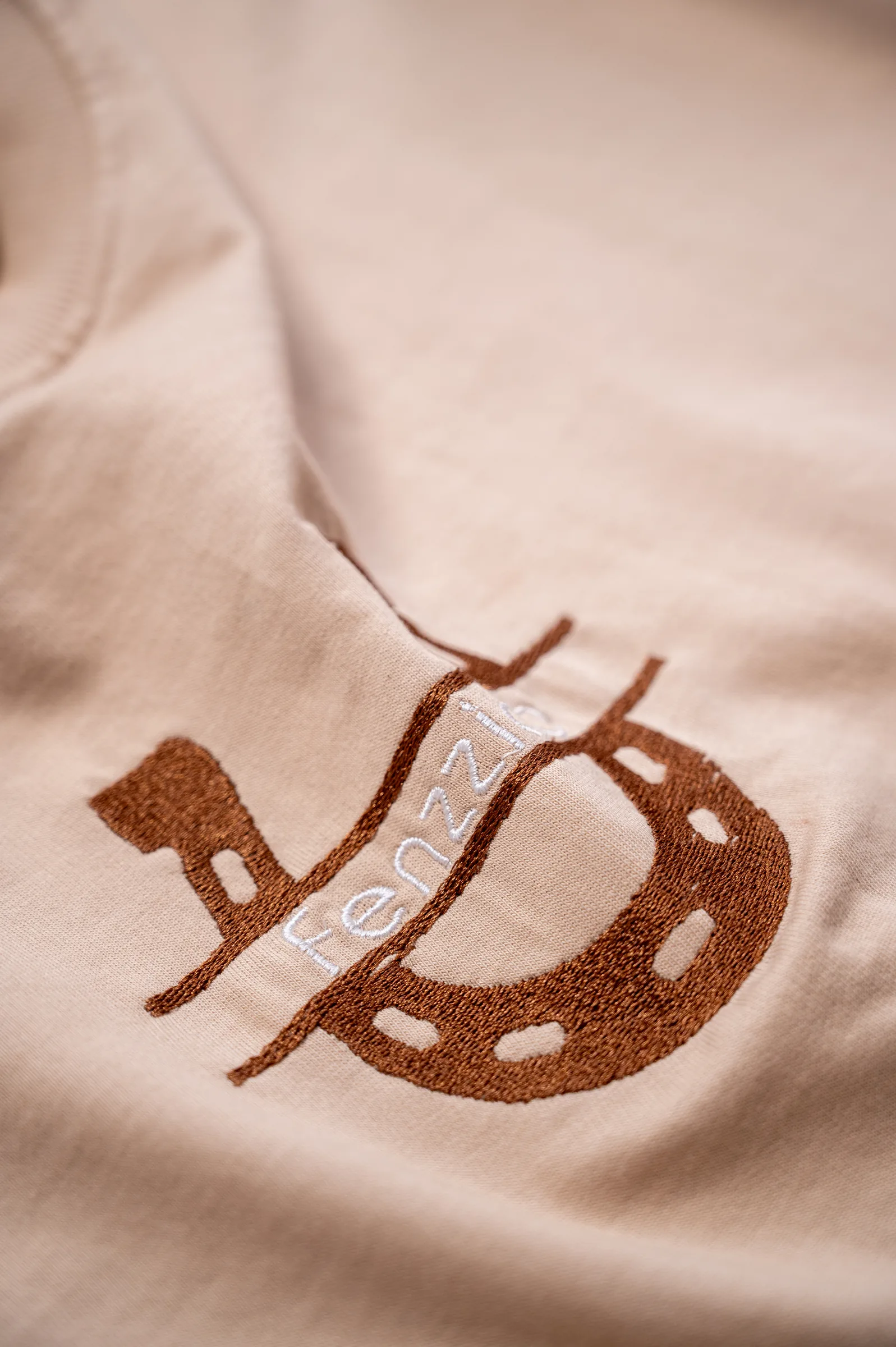 Close-up of the embroidered horseshoe and white Fenzzicio wordmark