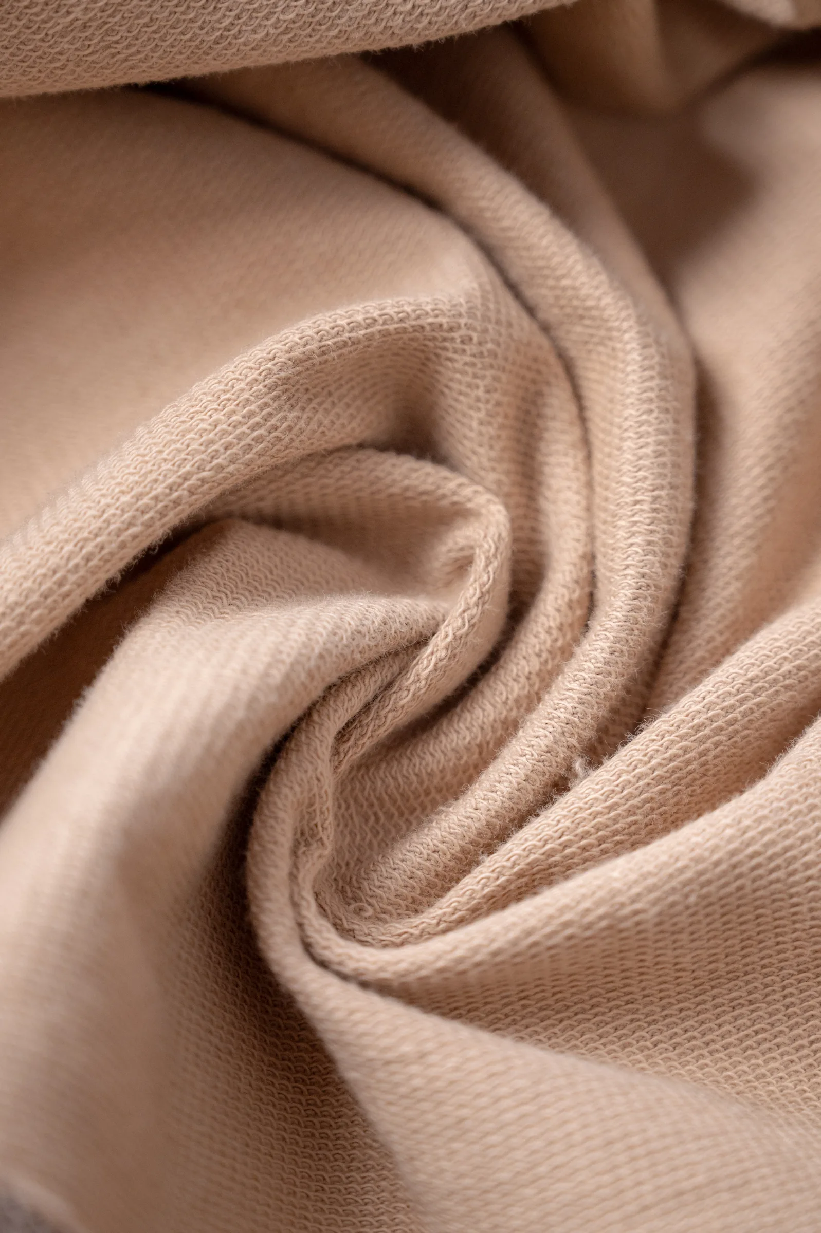 Close-up of the beige 240 GSM loopknit French terry fabric