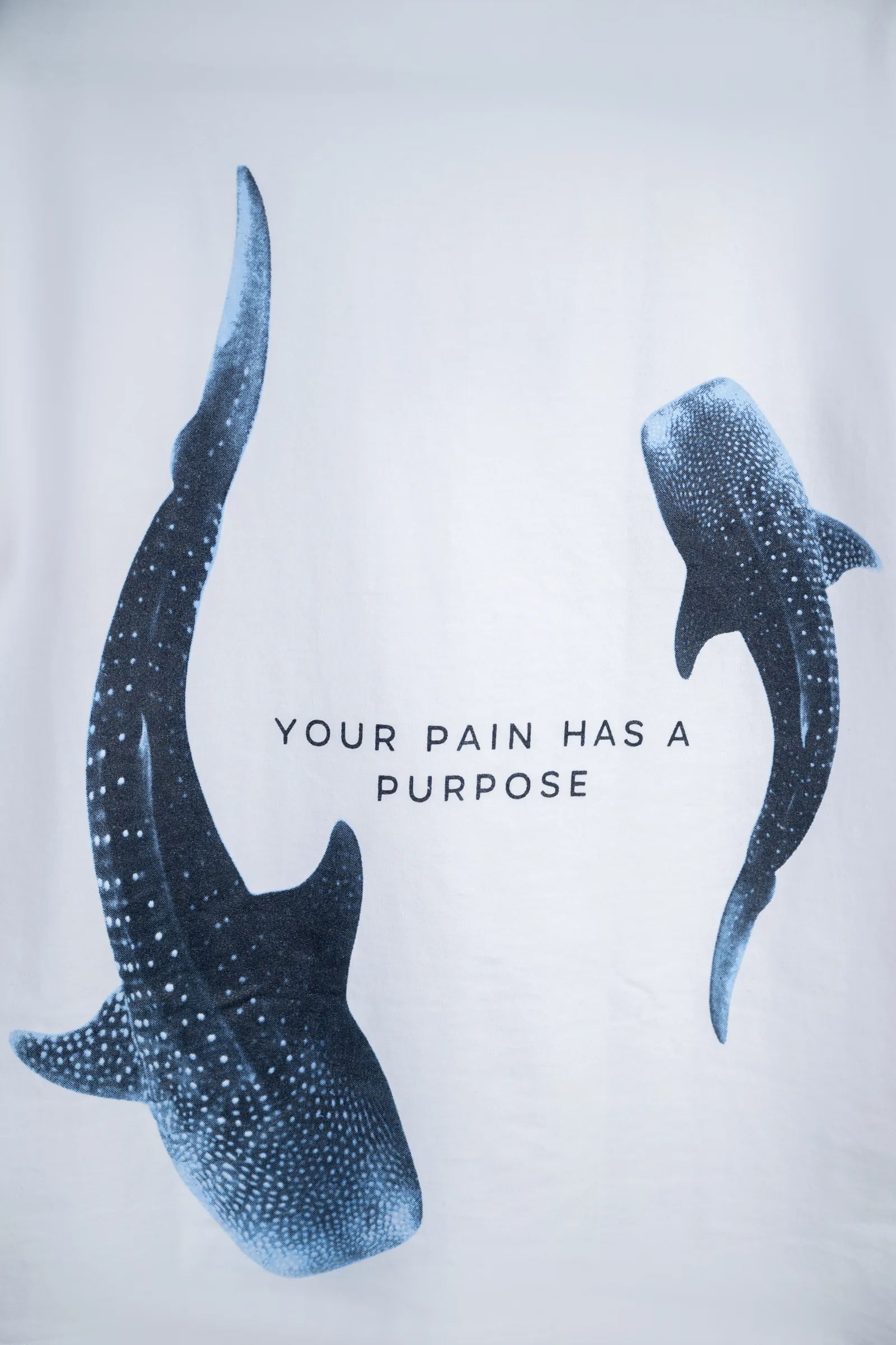 Back print detail: two whales with glitter-effect screen print and Your Pain Has A Purpose